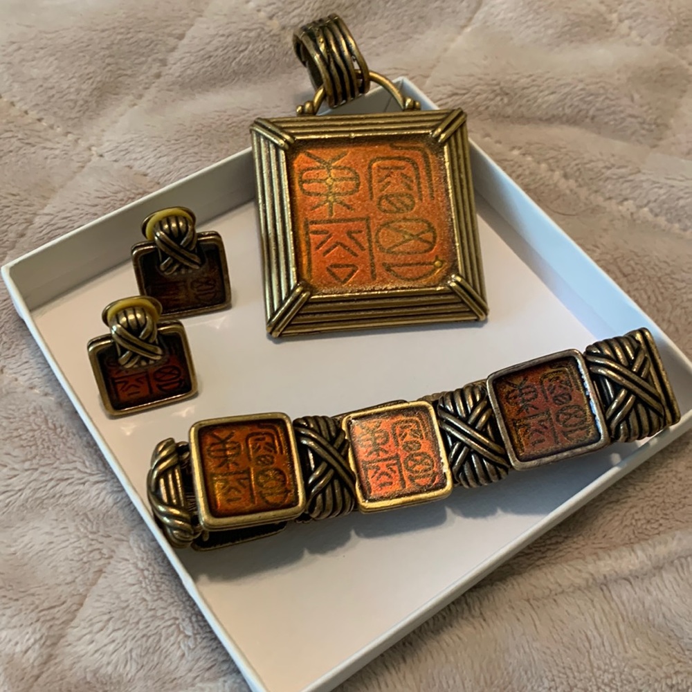 Gold and orange Chicos necklace, bracelet, and earrings set.